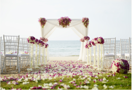 Petal laid beach wedding aisle with quare decorated at top of aisle