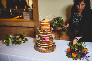 Wedding Planner arranging flowers on cake table